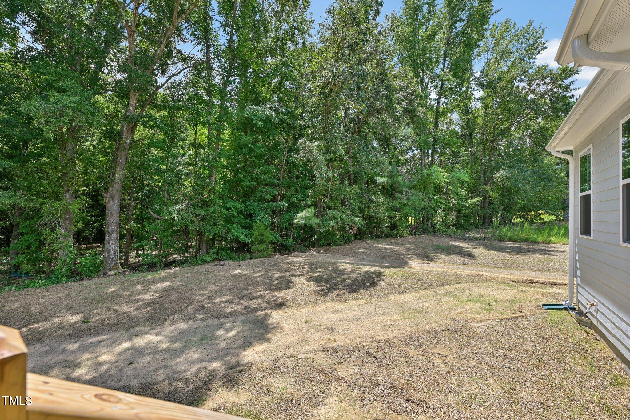 214 Alden Way Angier, NC 27501 - Photo 30 of 35 a view of a yard with plants and trees