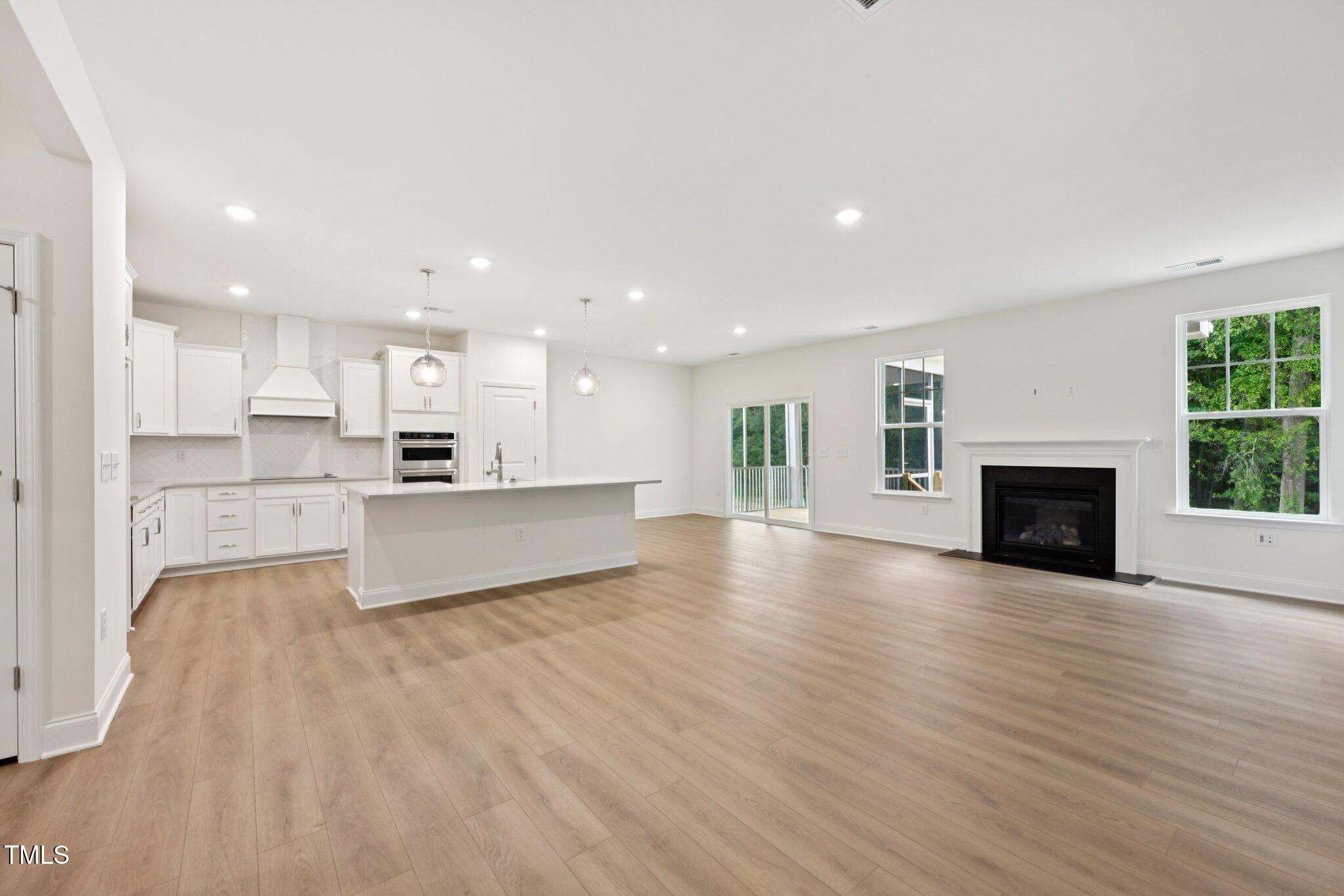 214 Alden Way Angier, NC 27501 - Photo 4 of 35 a view of kitchen with cabinets and wooden floor