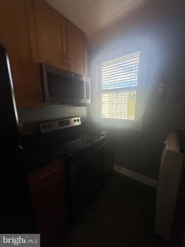 a kitchen with a refrigerator stove and microwave