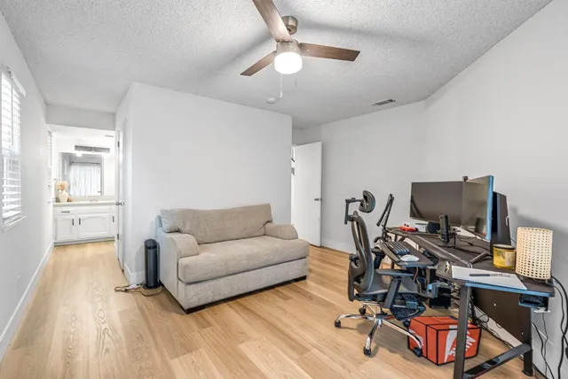 a bed room with a bed and a ceiling fan