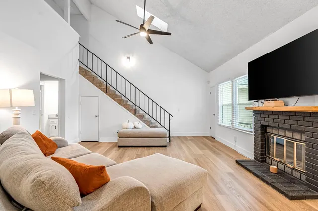 a living room with furniture and stairs
