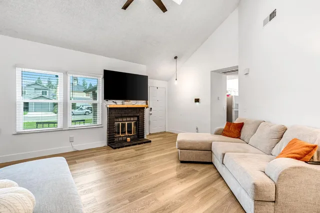 a kitchen with stainless steel appliances granite countertop a stove sink cabinets and wooden floor