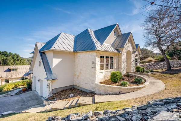 a front view of a house with garden