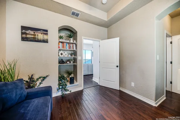 a view of living room filled with furniture and wooden floor