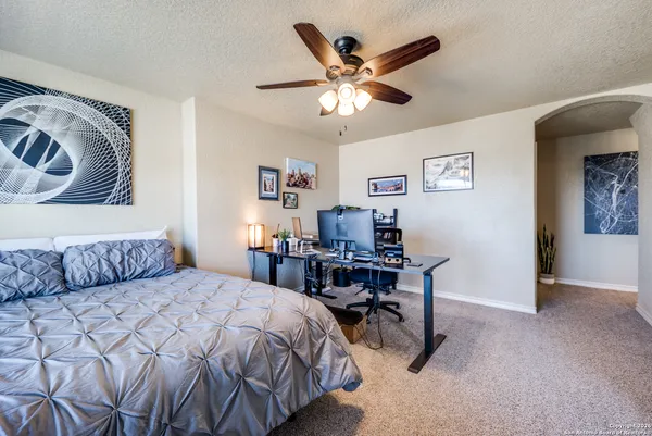 a bedroom with a large bed and a chandelier
