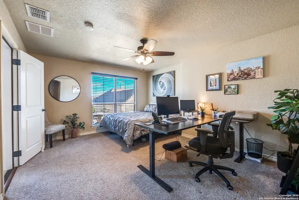 a view of a livingroom with workspace and a window