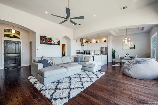 a living room with furniture and a chandelier