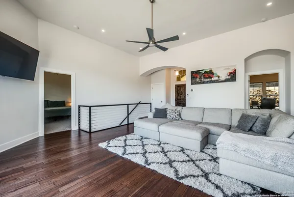a bedroom with furniture and a wooden floor