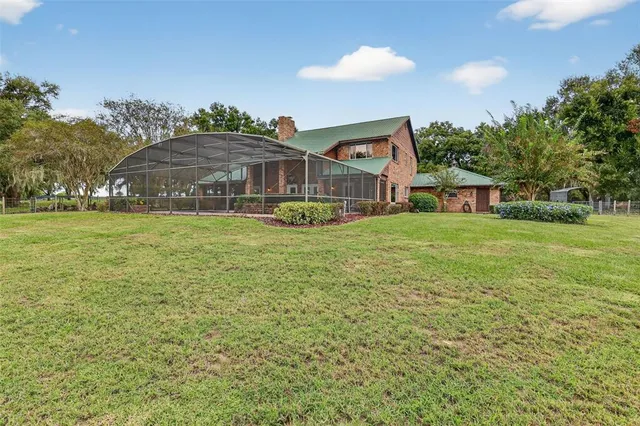a view of a livingroom with furniture staircase and a chandelier