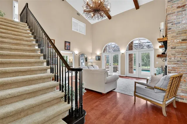 a kitchen with stainless steel appliances kitchen island granite countertop a sink and a refrigerator