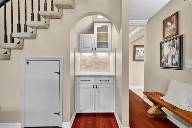 a view of a dining room with furniture large windows and wooden floor