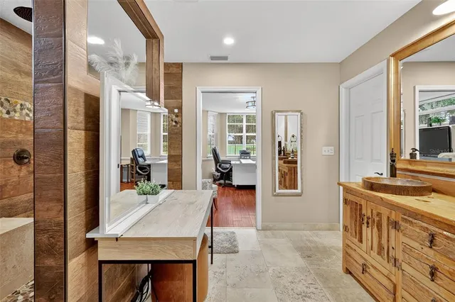 a bedroom with a large bed and a potted plant