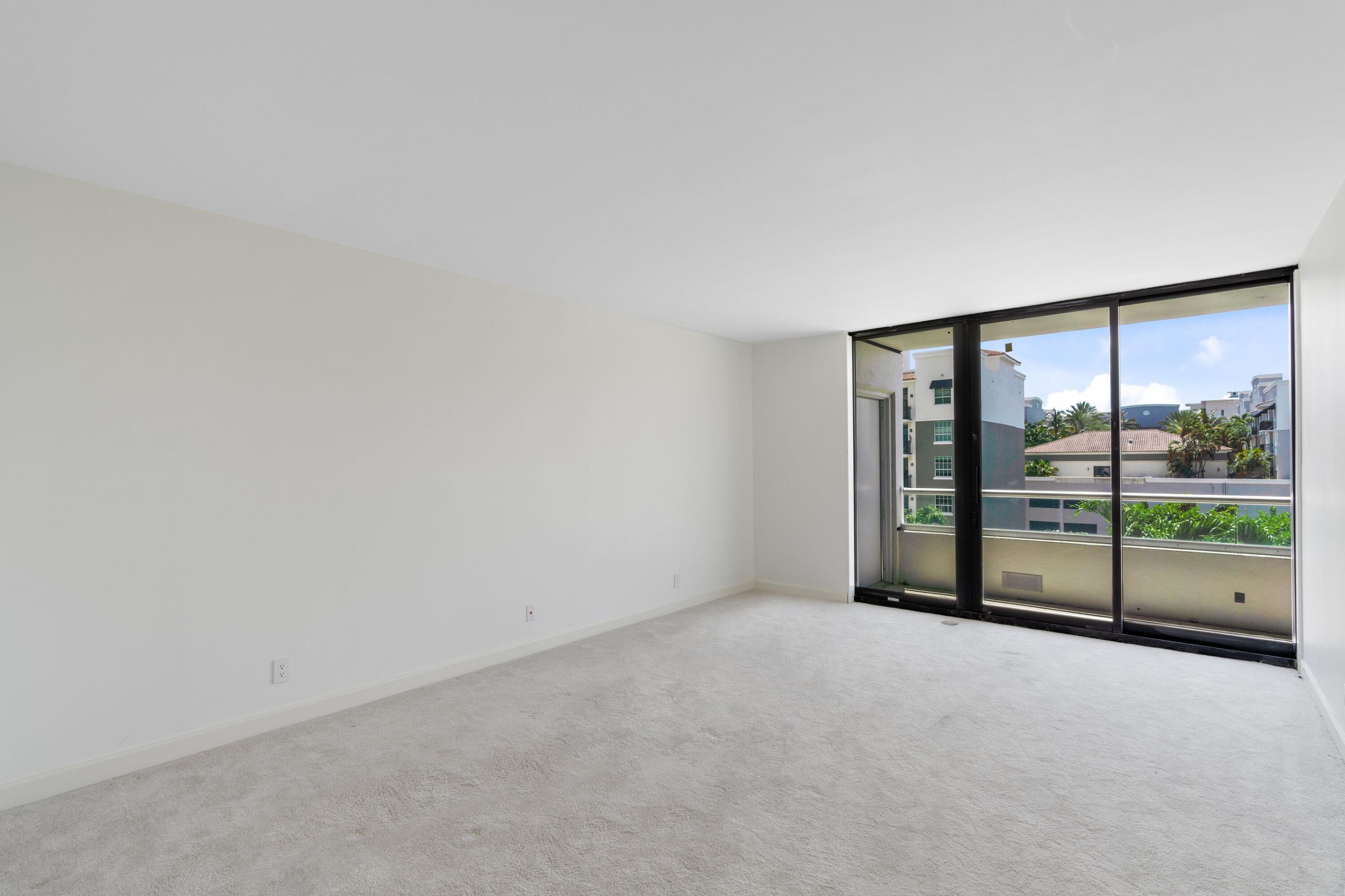 529 South Flagler Drive, Unit 6E West Palm Beach, FL 33401 - Photo 12 of 24 wooden floor in an empty room with glass door