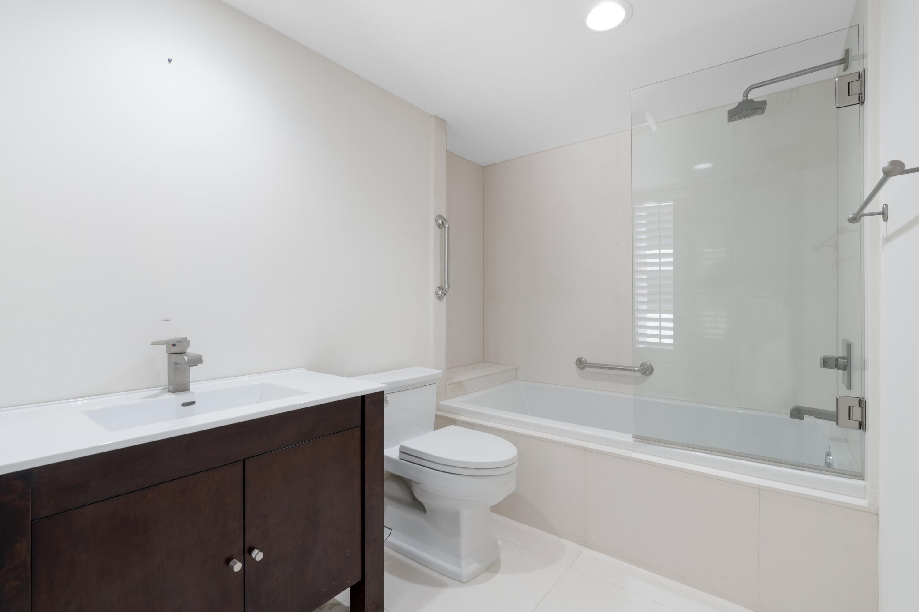 529 South Flagler Drive, Unit 6E West Palm Beach, FL 33401 - Photo 17 of 24 a bathroom with a sink a toilet and shower