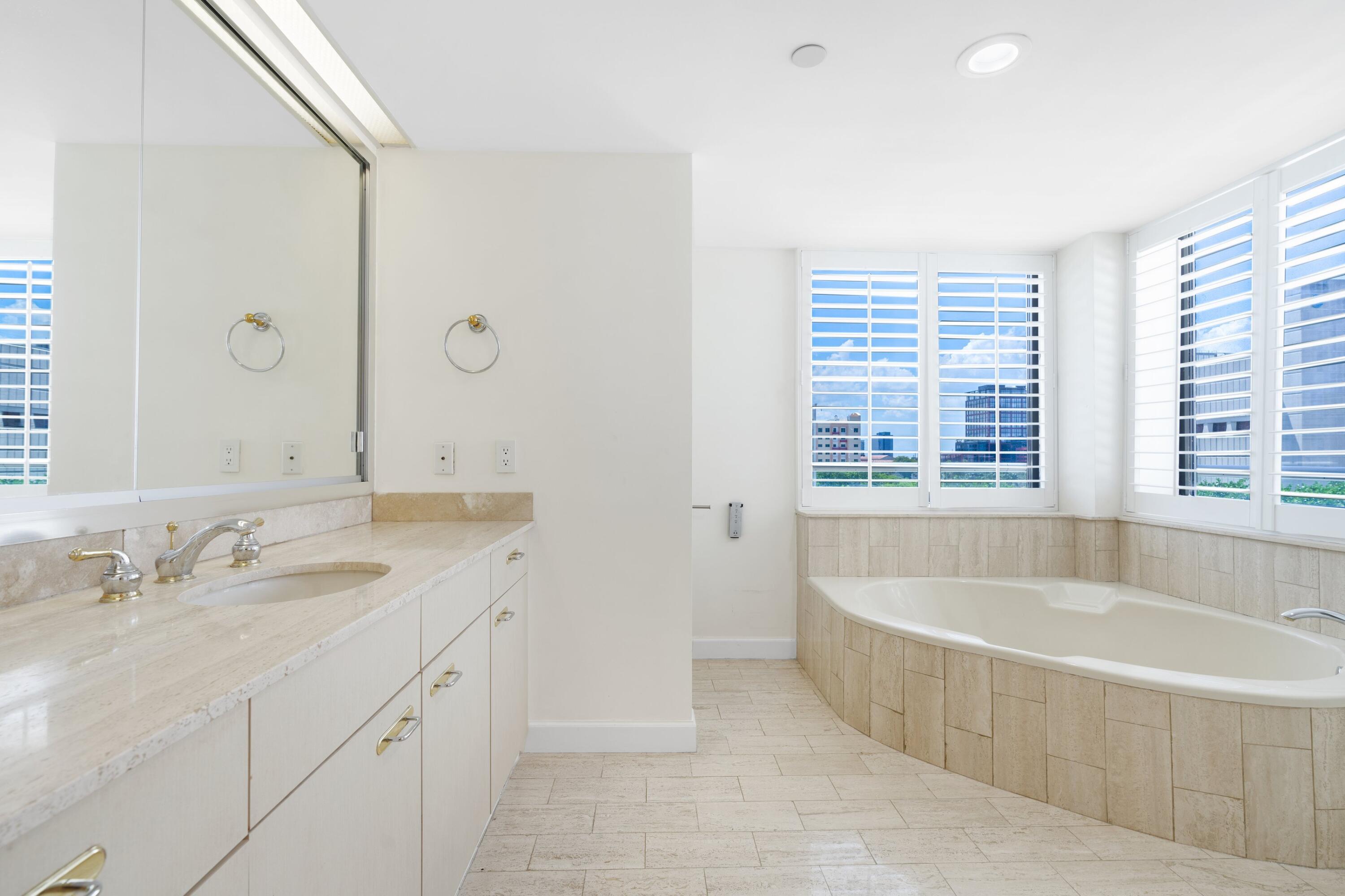 529 South Flagler Drive, Unit 6E West Palm Beach, FL 33401 - Photo 18 of 24 a spacious bathroom with sink shower and bathtub