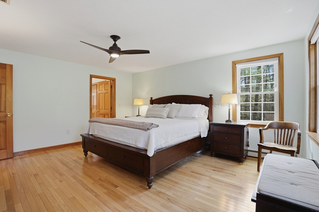 4 Charnock Circle Rutland, MA 01543 - Photo 23 of 42 a bedroom with a bed and wooden floor