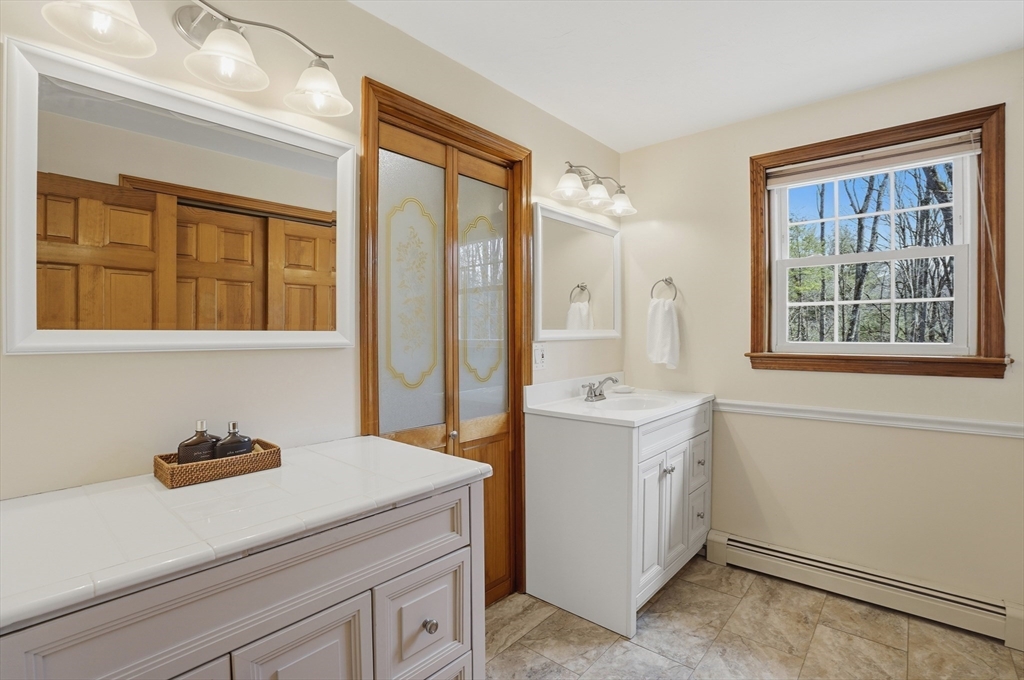 4 Charnock Circle Rutland, MA 01543 - Photo 25 of 42 a utility room with cabinets washer and dryer