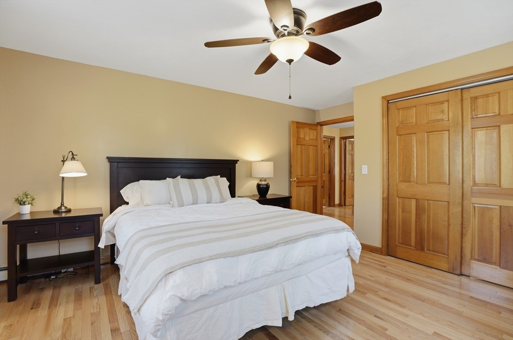 4 Charnock Circle Rutland, MA 01543 - Photo 33 of 42 a bedroom with a bed and a chandelier