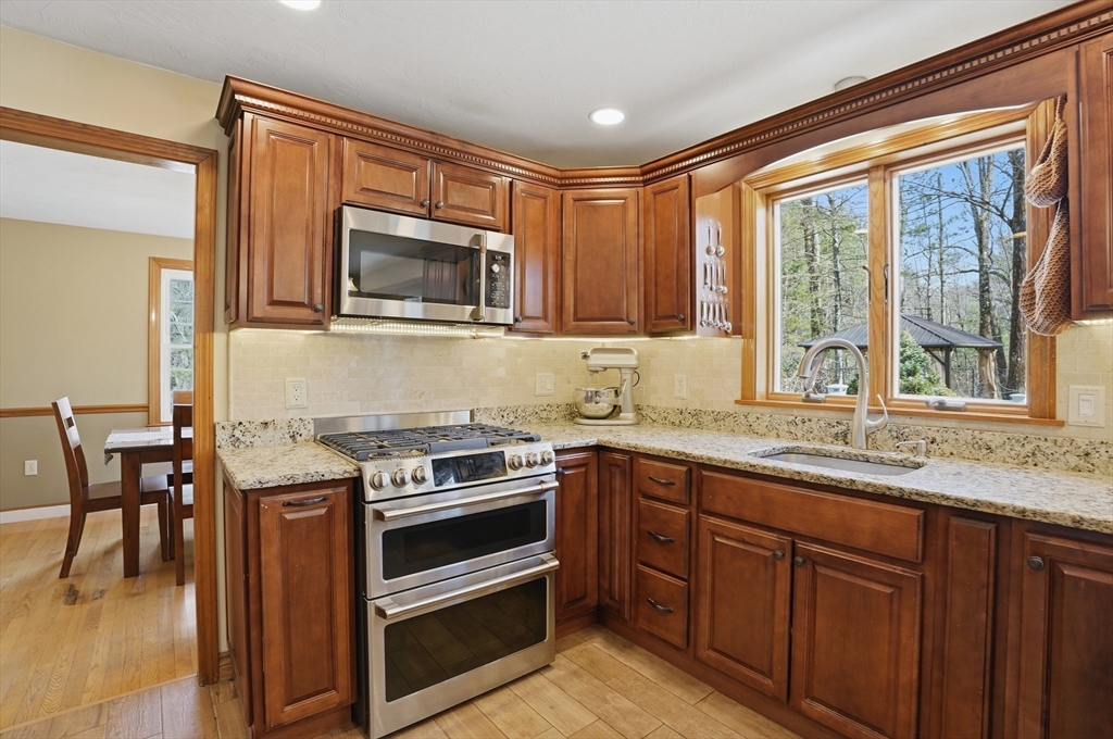 4 Charnock Circle Rutland, MA 01543 - Photo 7 of 42 a kitchen with stainless steel appliances granite countertop a stove a sink and a microwave