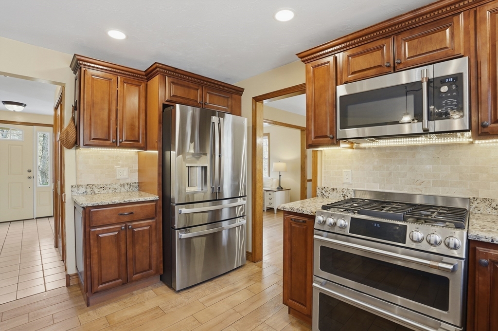 4 Charnock Circle Rutland, MA 01543 - Photo 9 of 42 a kitchen with stainless steel appliances granite countertop a refrigerator and a stove top oven