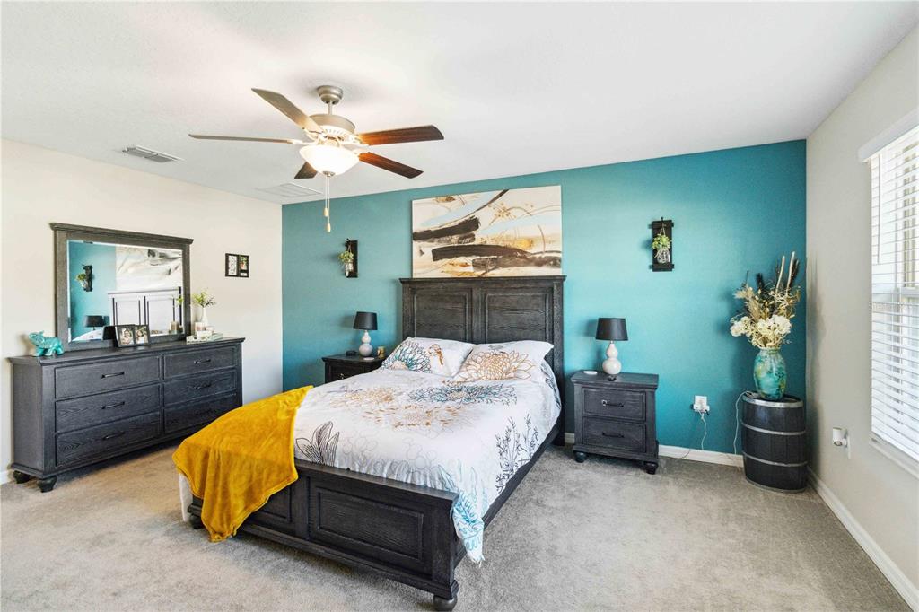 14339 Easy Goer Street Ruskin, FL 33573 - Photo 37 of 49 a bed room with a bed mirror and a window