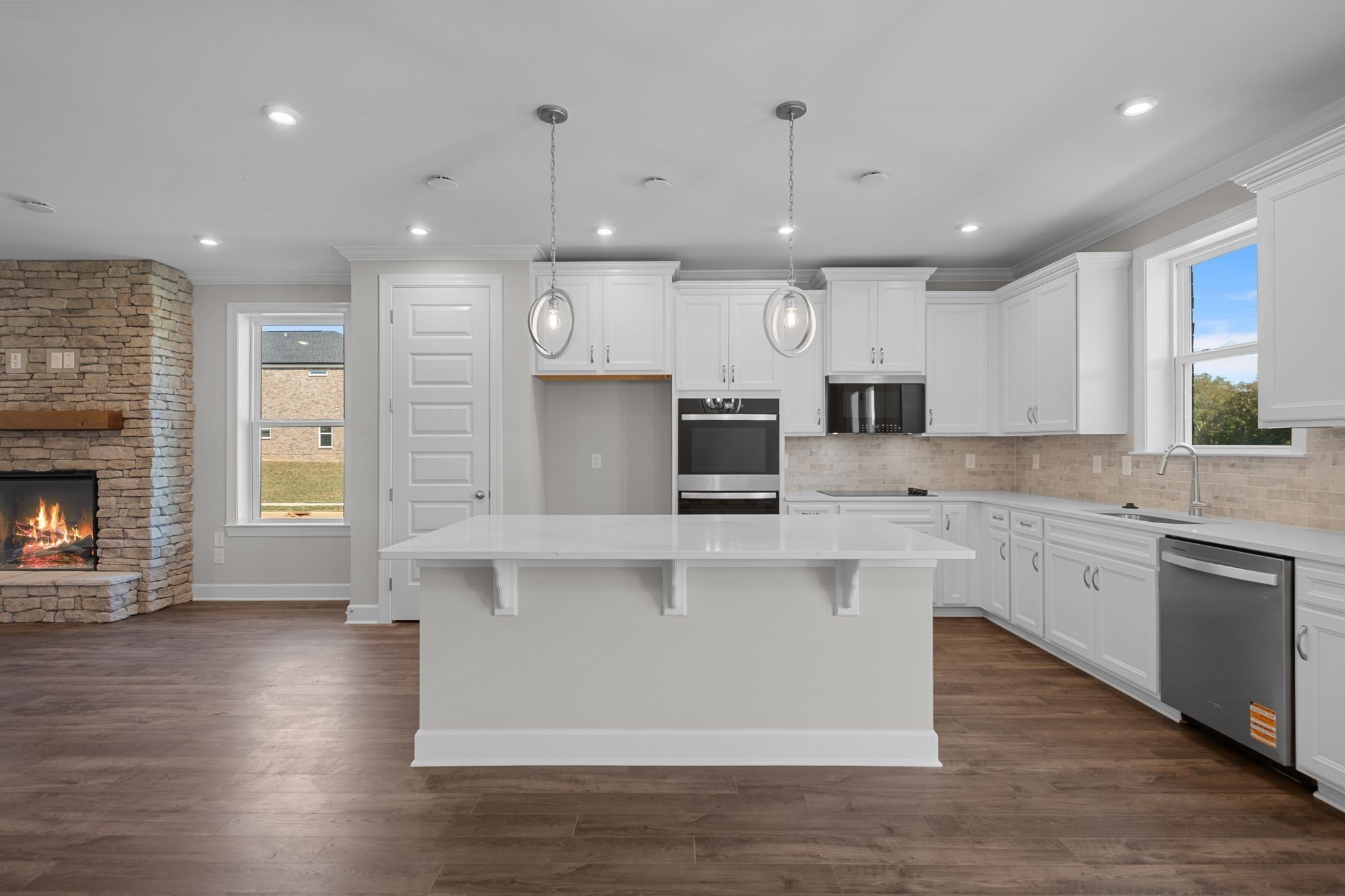 2001 Tee Time Trace Mount Juliet, TN 37122 - Photo 15 of 34 a large kitchen with stainless steel appliances granite countertop a stove a sink a refrigerator and white cabinets with wooden floor