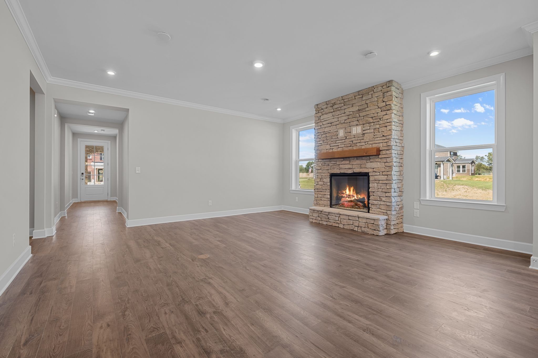 2001 Tee Time Trace Mount Juliet, TN 37122 - Photo 6 of 34 an empty room with wooden floor fireplace and windows