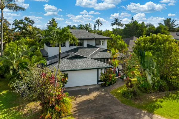 a view of a house with a plants and a yard with plants