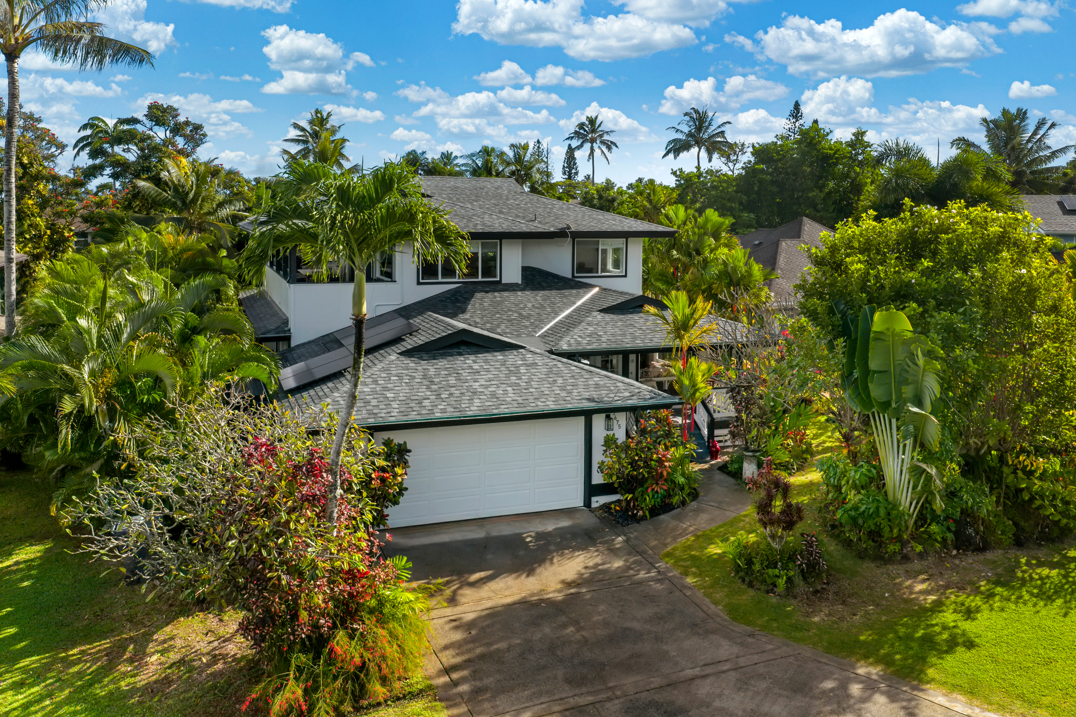 a view of a house with a plants and a yard with plants