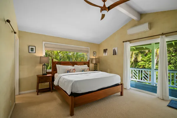 a bed sitting in a bedroom next to a window