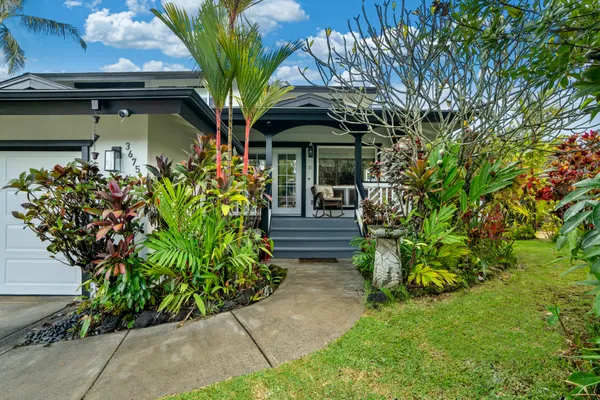 a front view of a house with garden