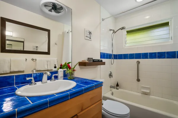 a bathroom with a sink a toilet and a mirror