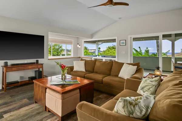 a living room with furniture and a floor to ceiling window