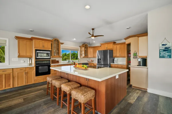 a large kitchen with a table and chairs