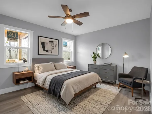 a bedroom with a bed a mirror and a large window