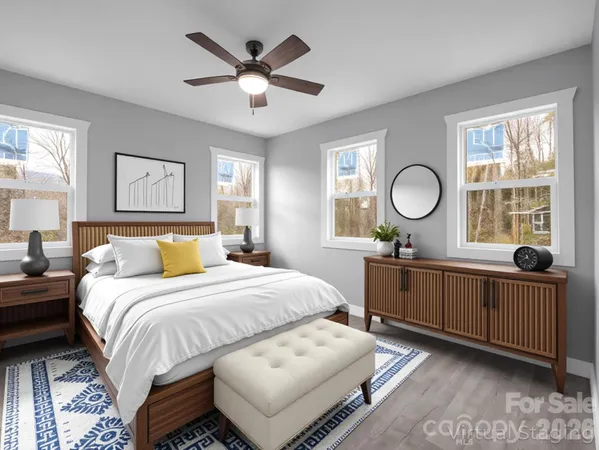 a bedroom with a large bed and a window