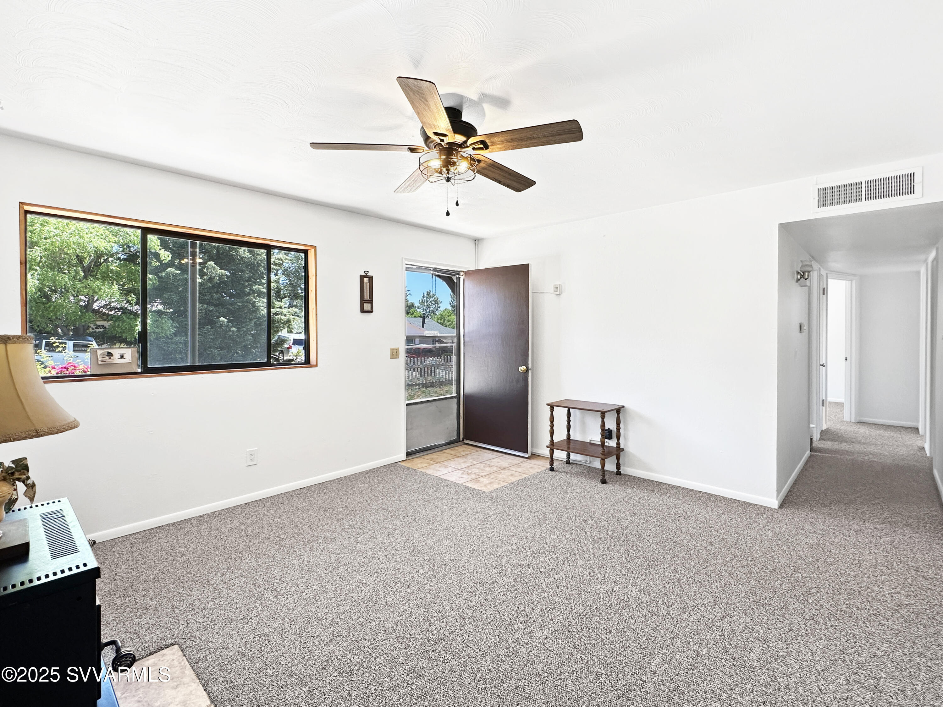 3219 North Manor Road Flagstaff, AZ 86004 - Photo 4 of 23 a view of a livingroom with a ceiling fan and window