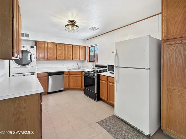 a kitchen with a sink appliances and cabinets