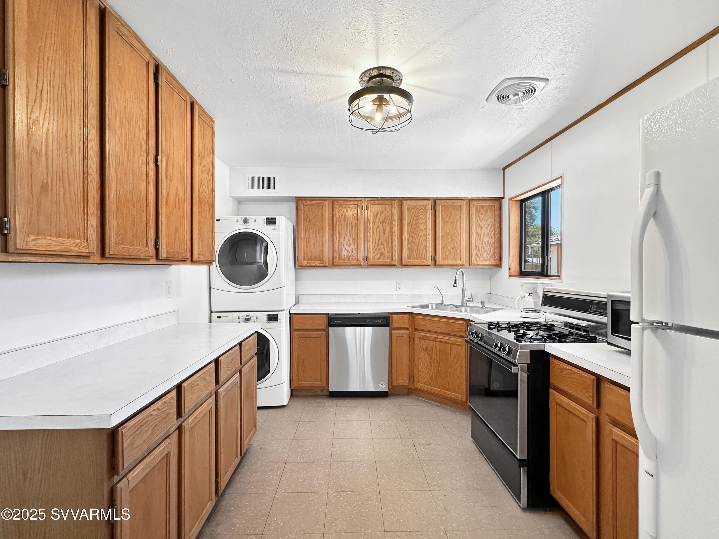3219 North Manor Road Flagstaff, AZ 86004 - Photo 7 of 23 a kitchen with stainless steel appliances granite countertop a stove and a sink