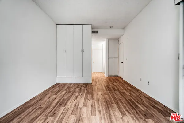 a view of a room with wooden floor