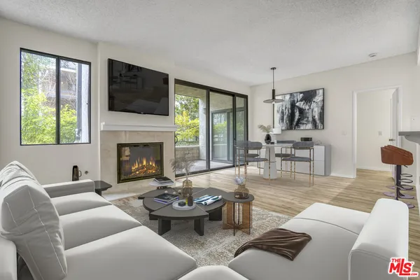 a living room with furniture fireplace and window