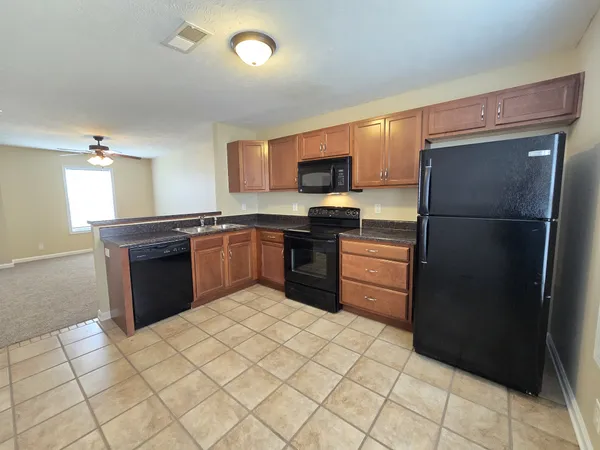 a kitchen with a sink stove and refrigerator