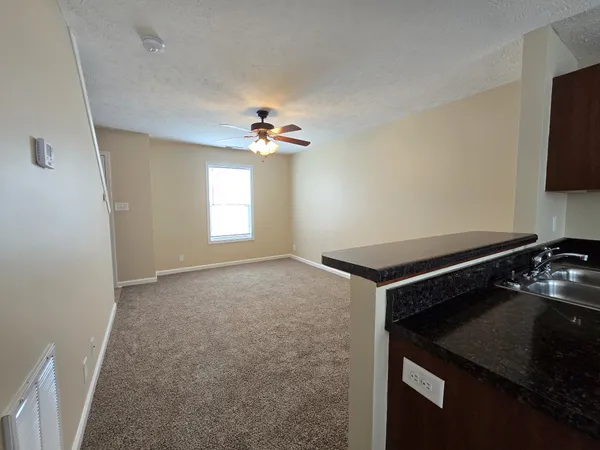 a kitchen with a stove and a white cabinet