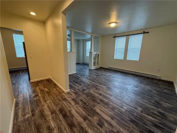 wooden floor in an empty room with a window