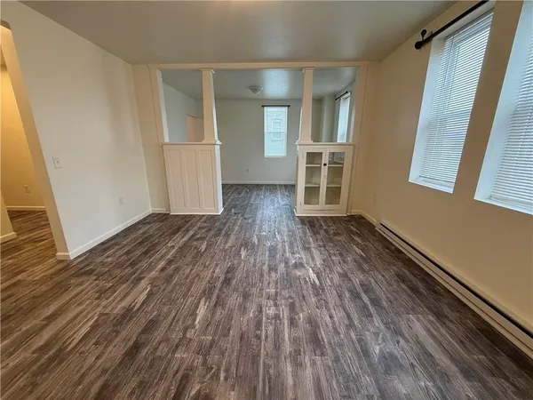 wooden floor in an empty room with a window