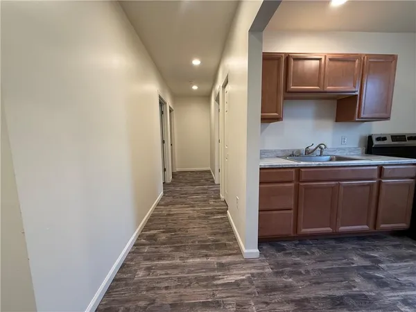 a kitchen with stainless steel appliances granite countertop a sink stove and cabinets