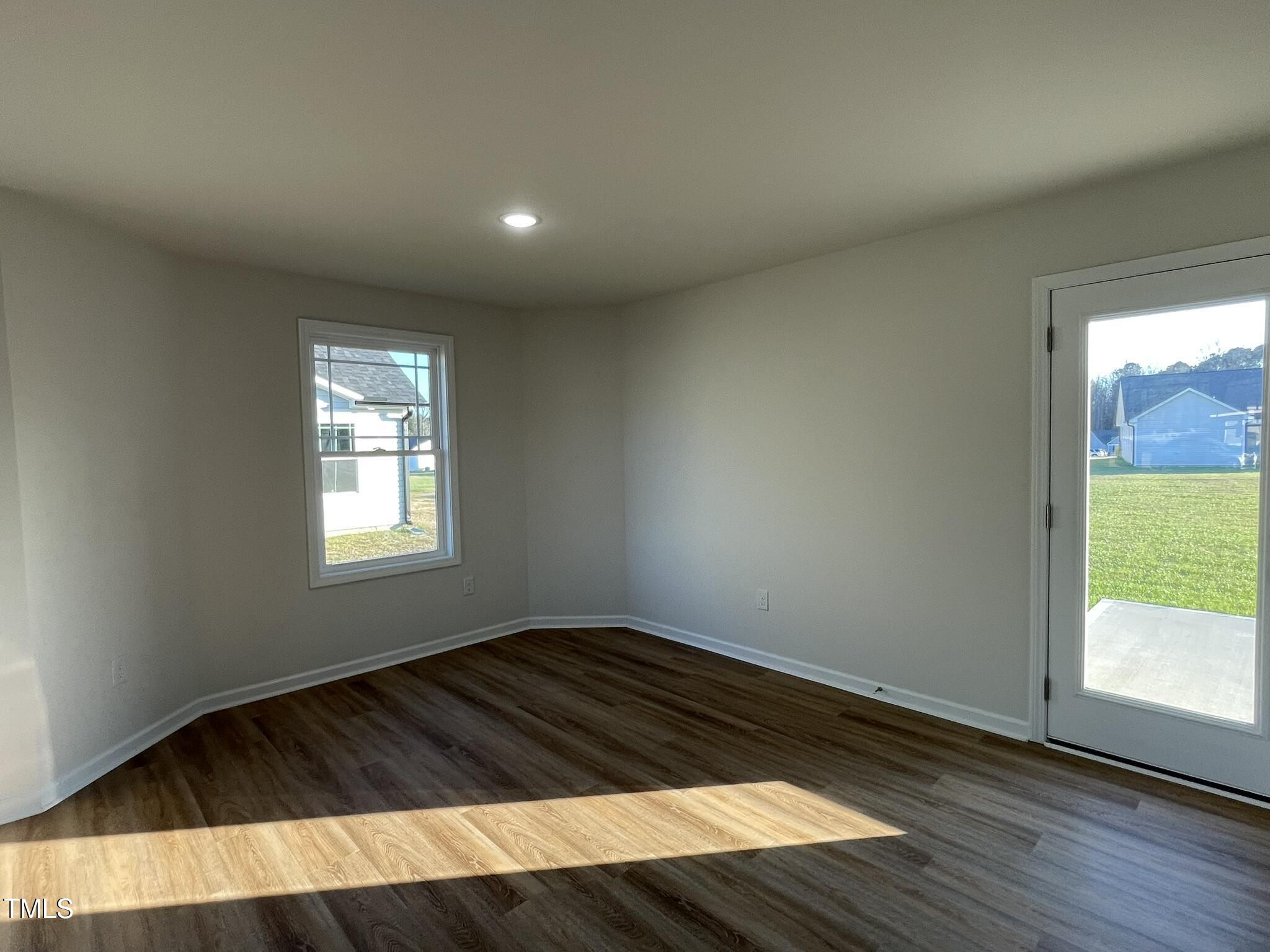 12 Flatland Drive Princeton, NC 27569 - Photo 4 of 20 an empty room with wooden floor and windows