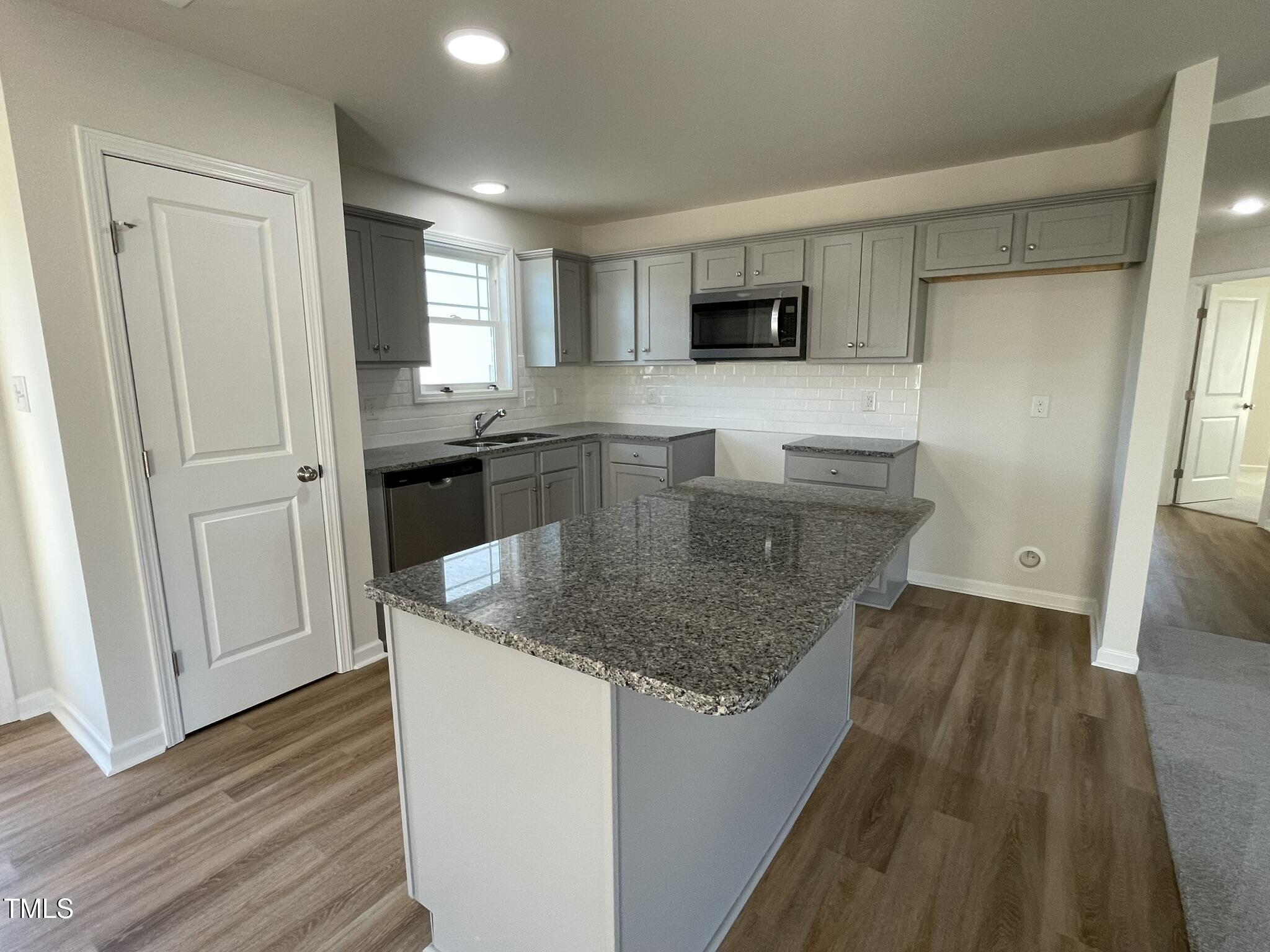 12 Flatland Drive Princeton, NC 27569 - Photo 5 of 20 a kitchen with stainless steel appliances granite countertop a sink stove and refrigerator