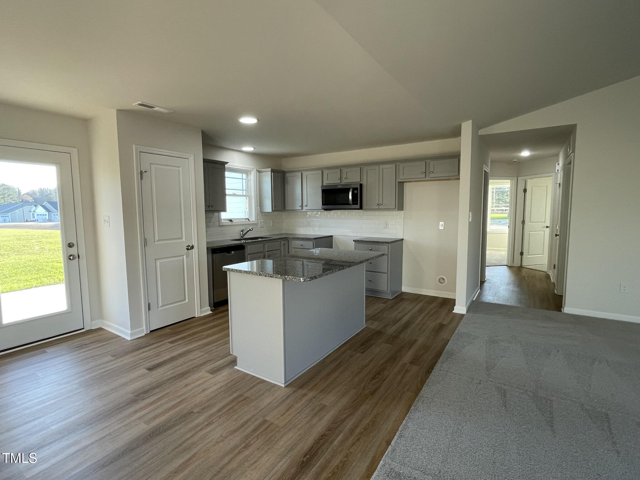 12 Flatland Drive Princeton, NC 27569 - Photo 7 of 20 a large kitchen with cabinets and wooden floor