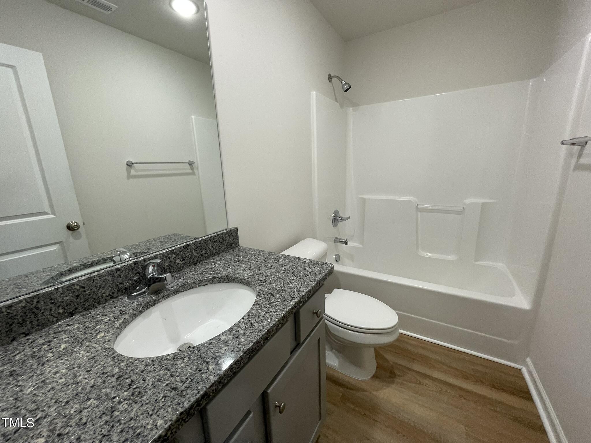 12 Flatland Drive Princeton, NC 27569 - Photo 8 of 20 a bathroom with a granite countertop sink toilet a mirror and shower